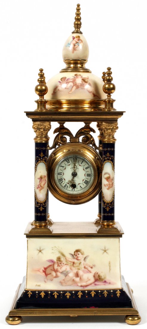 ROYAL VIENNA PORCELAIN CATHEDRAL STYLE MANTEL CLOCK: ROYAL VIENNA PORCELAIN CATHEDRAL STYLE MANTEL CLOCK, H 16 1/2" D 7":Decorated with hand painted cherub scenes. Movement appears to have been replaced. For a high resolution photo