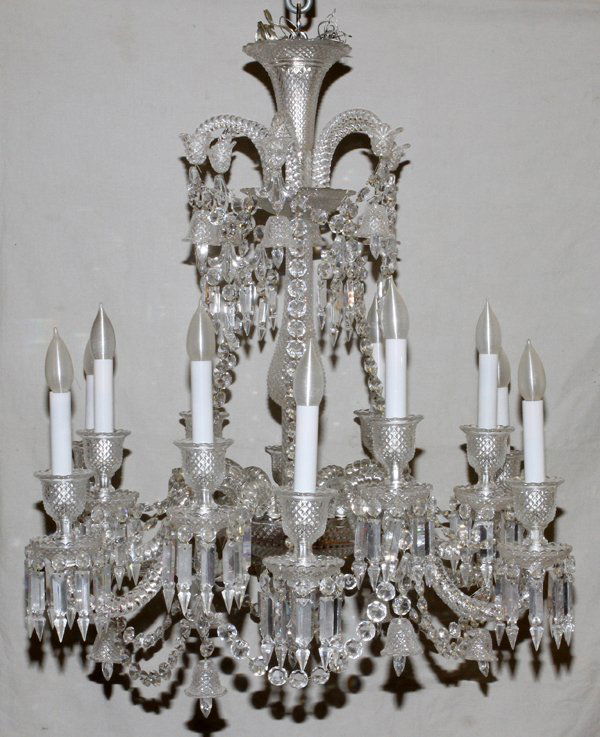 BACCARAT ZENITH TWELVE-LIGHT CRYSTAL CHANDELIER: BACCARAT ZENITH TWELVE-LIGHT CRYSTAL CHANDELIER, H 32", DIA 30": Featuring twelve scroll arms with candleholder forms, above the bobeches, supporting the lights. Having crystal bell form prisms and su