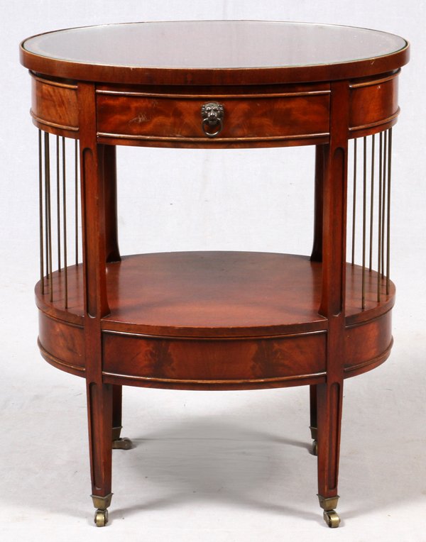 MAHOGANY OVAL TABLE C. 1940: MAHOGANY OVAL TABLE, C. 1940, H 27", W 22", D 16":Tooled leather top, brass decorative rods. For a high resolution photo CLICK HERE