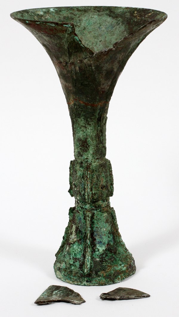 CHINESE ARCHAIC BRONZE GU OR RITUAL WINE VESSEL: CHINESE ARCHAIC BRONZE GU, OR RITUAL WINE VESSEL, H 10":An archaic bronze vessel, H.10", possibly Shang Dynasty. Provenance: From the collection of G. G. Scranton, friend and travel companion of Mrs. 