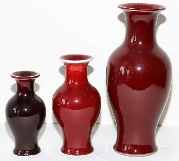 CHINESE OX BLOOD VASES THREE: CHINESE OX BLOOD VASES, THREE, H 5 1/2"-10":Three baluster form vases, two are stamped in blue at the underside. For a high resolution photo CLICK HERE