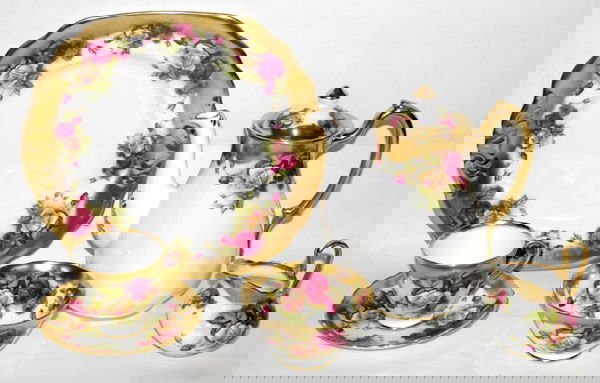 ROYAL CHELSEA, PORCELAIN TEA SET, GOLDEN ROSE: ROYAL CHELSEA, ENGLISH PORCELAIN TEA SET, 'GOLDEN ROSE' PATTERN, 19 PIECES:Including 1 teapot, H.7 1/2", 1 creamer, 1 sugar bowl, 1 cake plate, W.9 1/2", 7 cups and 8 saucers.