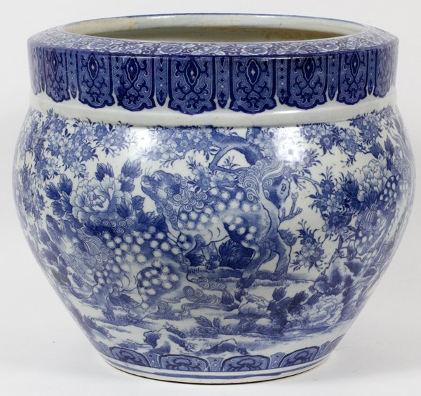 CHINESE BLUE & WHITE PORCELAIN JARDINIÈRE 19TH C.: CHINESE BLUE & WHITE PORCELAIN JARDINIÈRE, 19TH C., H 15", DIA 15":Blue on white, motif of fu dogs among chrysanthemums. From a prominent Dearborn Heights, Mi. collector. For a high resolution photo