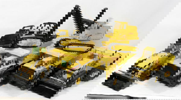 TONKA TRUCKS, BULLDOZERS, BACK HOE, TRACTOR: TONKA STEEL RUBBER TIRE TRUCKS, BULL DOZERS, BACK HOE, TRACTOR, C1970, SIX:Yellow Tonka steel with rubber tires equipment vehicles. Two dump trucks L17" x W8" x H10". Bull dozer L19" x H10". Bull doze