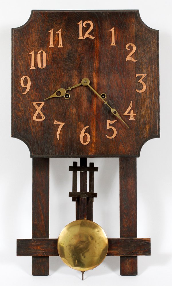 MISSION STYLE OAK WALL CLOCK: MISSION STYLE OAK WALL CLOCK, H 24", L 13":Having a square shape face with copper Arabic numerals and brass hands. Having an adjustable pendulum with brass disk weight. For a high resolution photo