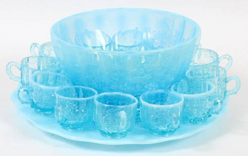 LIGHT BLUE GLASS PUNCH BOWL SET: LIGHT BLUE GLASS PUNCH BOWL SET, H 5", DIA 10":Light blue bowl with shallow fluted sides with floral designs along with 12 punch cups and a round tray, 14" Dia. For a high resolution photo