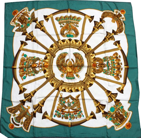 HERMES 'EGYPTE' SILK SCARF: HERMES 'EGYPTE' SILK SCARF, 34" X 34":Or "Scarabees et Pectoraux", in shades of cream and golden yellow within a green border; signed within the print, designed by Caty Latham. Labeled: Hermes, Made i