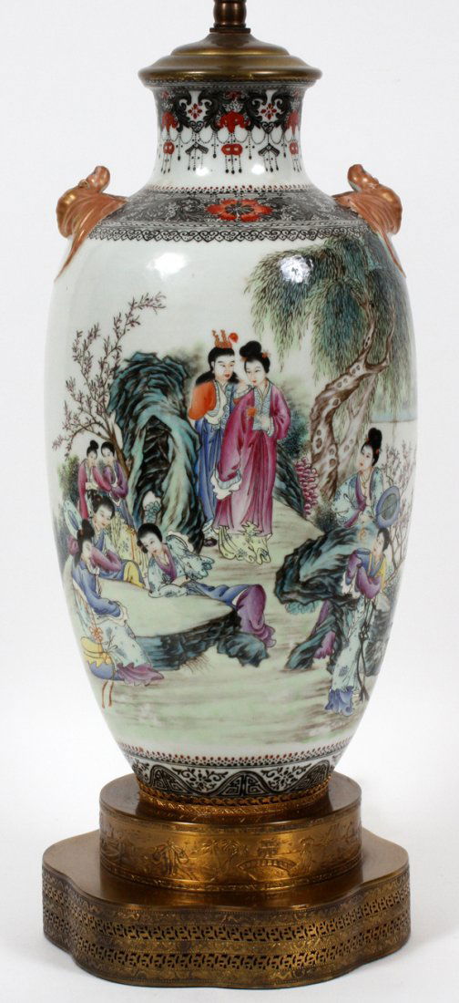CHINESE PORCELAIN HAND PAINTED TABLE LAMP: CHINESE PORCELAIN HAND PAINTED TABLE LAMP, H 32":Has jade finial. Oriental figures in landscape surround. Fired gold foo dogs in relief. Stamped signatures on body of lamp. Gilt metal base depicting o