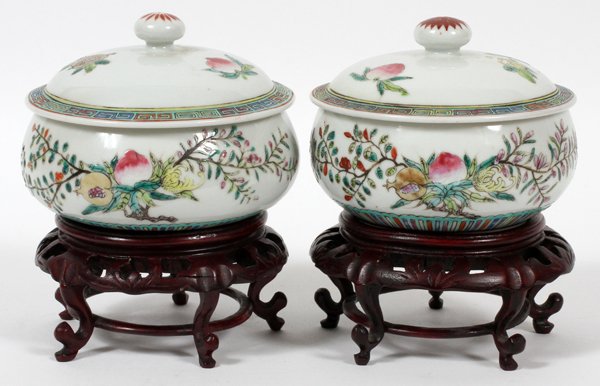 CHINESE HAND PAINTED PORCELAIN COVERED POTS PAIR: CHINESE HAND PAINTED PORCELAIN COVERED POTS, PAIR, H 3 3/4", DIA 5":Having white background with peach, vine and flower motif with lid and teakwood base. Marks on bottom. For a high resolution photo