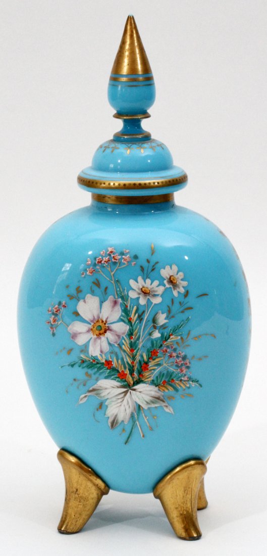 ENGLISH BRISTOL GLASS DRESSER JAR 19TH C.: ENGLISH BRISTOL GLASS DRESSER JAR, 19TH C., H 12", DIA 5 1/2":Blue Bristol glass, floral enamel decorated on four fired gold feet, with lid. From the estate of Barbara K. Wrigley of Grosse Pointe Farm