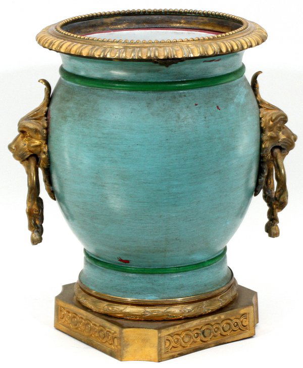 FRENCH BRONZE-MOUNTED PORCELAIN JARDINIÈRE: FRENCH BRONZE-MOUNTED PORCELAIN JARDINIÈRE, H 14 1/2", W 12":Having a scalloped bronze rim, bronze mounted lion and ring handles, on a bronze base. From the estate of Barbara K. Wrigley of Grosse Poi