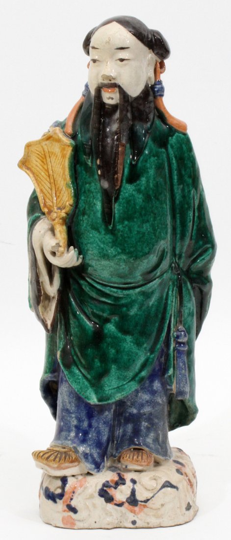 CHINESE POTTERY FIGURE OF ELDER: CHINESE POTTERY FIGURE OF ELDER, H 15":Painted in a green and blue glaze. Character marks on underside. From the estate of Barbara K. Wrigley of Grosse Pointe Farms. For a high resolution photo
