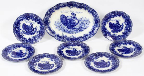 WEDGWOOD & CO. TRANSFER PLATTER & PLATES C. 1910: WEDGWOOD & CO. 'CLYTIE' FLOW BLUE TRANSFER TURKEY PLATTER & PLATES, C. 1910, SET OF EIGHT PIECES:Demi porcelain set with turkey motif, scalloped and embossed about the rim, including 1 oval platter, L