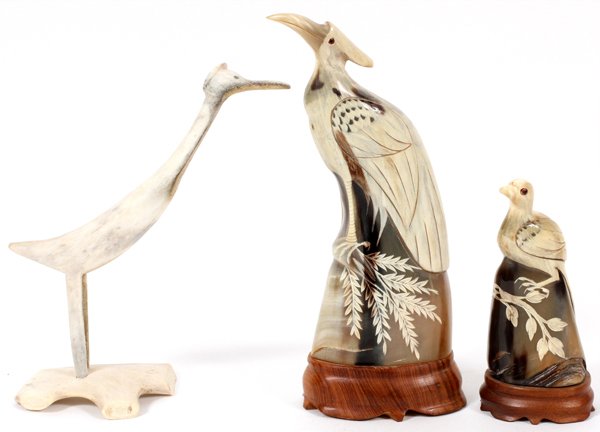 CARVED BONE & HORN BIRDS 3 PIECES: CARVED BONE & HORN BIRDS, 3 PIECES, H 6 1/2"- 11":Including 1 stylized bone bird, and 2 other horn birds with carved foliate details, each fitted to a teakwood stand.