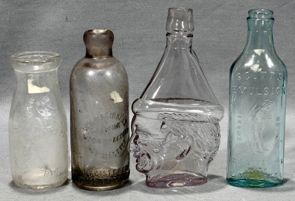 BOTTLES, INCL WM. FRIEDMAN, KEY WEST & SCOTT'S: ANTIQUE GLASS BOTTLES, INCLUDING WM. FRIEDMAN SODA, KEY WEST, & SCOTT'S EMULSION, FOUR TOTAL:Includes Scott's Emulsion, 7 1/2"; Jersey Farms Dairy Co. 5 1/2"; clown head 7 1/2".