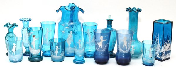 MARY GREGORY ANTIQUE BLUE GLASS TABLEWARE 15 PIECES: MARY GREGORY, ANTIQUE BLUE GLASS TABLEWARE, 15 PIECES, H 3 3/4"-9 1/2":Including 1 pitcher, with 1 tumbler, and 1 bottle, as well as 11 vases, decorated with children, together with 1 squared vase dec