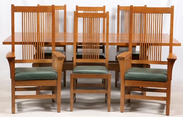 STICKLEY HANDCRAFT CRAFTSMAN OAK DINING SET: STICKLEY HANDCRAFT CRAFTSMAN OAK LATE 20TH C. DINING SET WITH SIX CHAIRS & DOUBLE TRESTLE TABLE, H 30", W 42", L 90":Two open armchairs and four side chairs with green leather inset seats having both