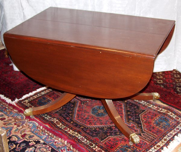 BAKER, DUNCAN PHYFE STYLE DROP-LEAF TABLE: BAKER, DUNCAN PHYFE STYLE MAHOGANY DROP-LEAF TABLE WITH THREE LEAVES, H 29", W 42", L 56":with reeded legs and brass paw feet. With three numbered leaves at 14" each and drop sides.