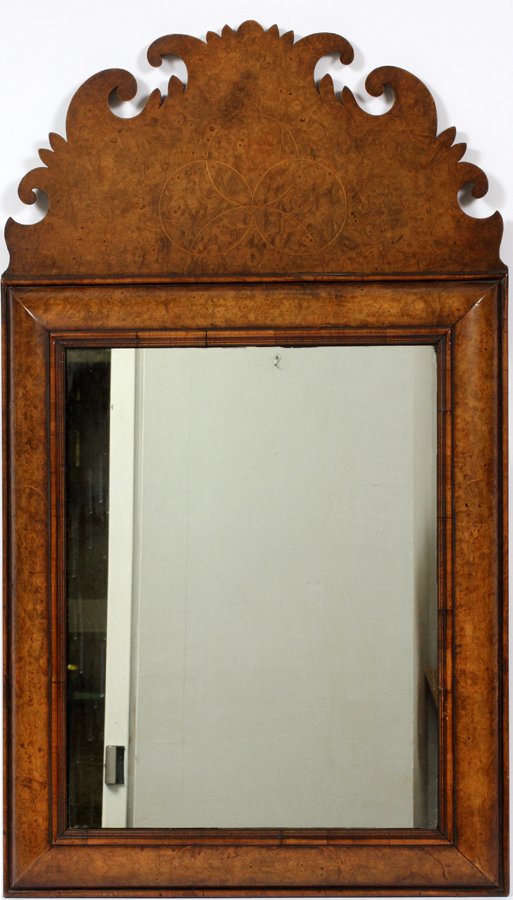 ENGLISH BURL WOOD MIRROR: ENGLISH BURL WOOD MIRROR, H 37 1/2", W 22":A scalloped crest and stylized shamrock design on a convex form frame. From the Estate of Daniel Clancy, Voltaire Place, Grosse Pointe Farms.
