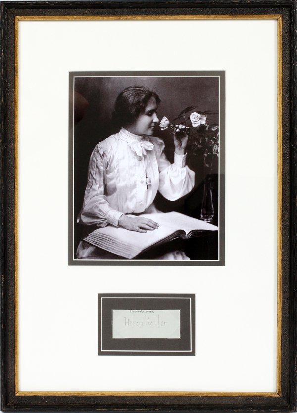 HELLEN KELLER CUT AUTOGRAPH & PHOTOGRAPH: HELLEN KELLER CUT AUTOGRAPH AND BLACK AND WHITE PHOTOGRAPH, H 14", W 8":Includes a cut autograph in black ink and a black and white photograph of Keller sitting at a table smelling a flower with a boo