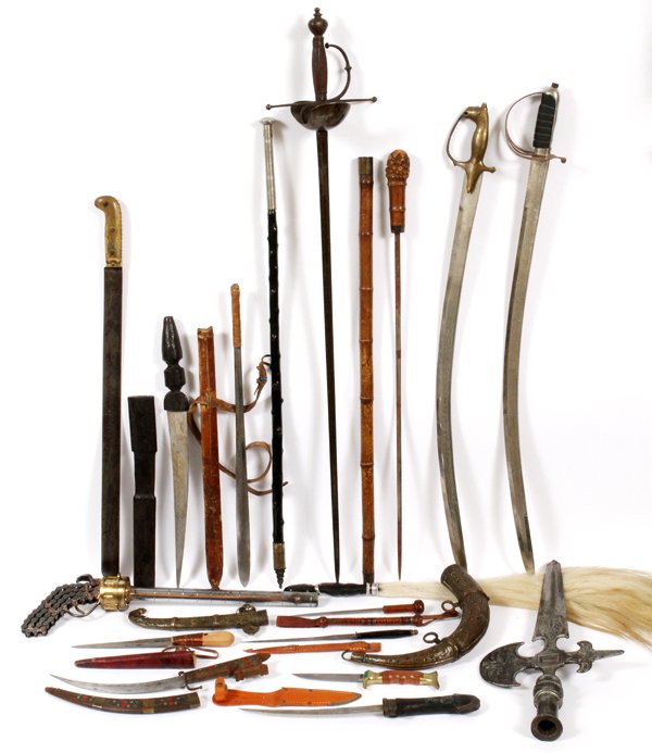 ANTIQUE CEREMONIAL SWORD AND KNIFE COLLECTION: ANTIQUE CEREMONIAL SWORD AND KNIFE COLLECTION, 18 PIECES:Including: One Indian Saber; One Spanish sword w/shell guard; Persian Daggers; Spanish sword with wooden handle; Persian Brass powder horn (19t