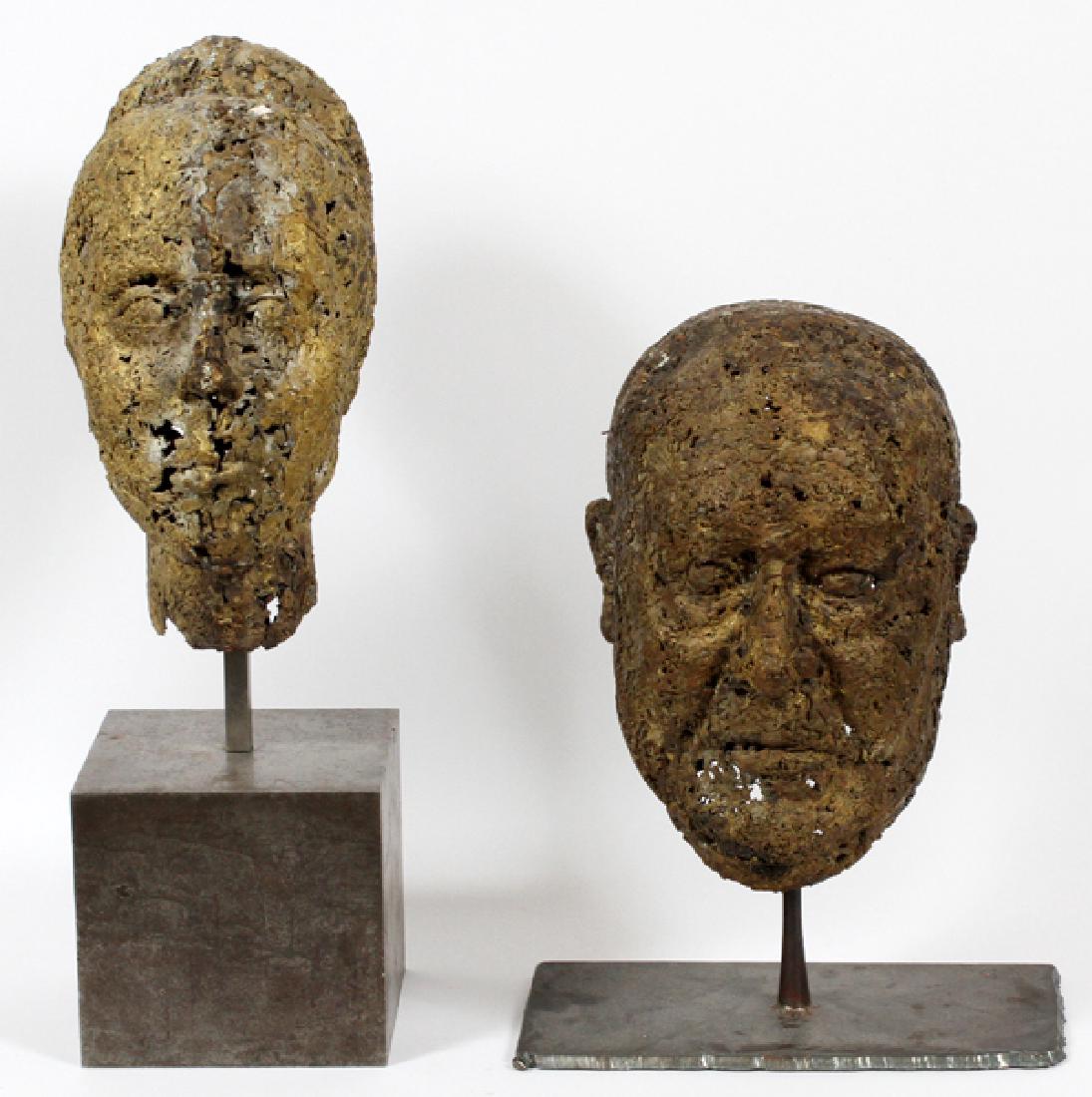 METAL MALE & FEMALE HEAD SCULPTURES PAIR: METAL MALE & FEMALE HEAD SCULPTURES, PAIR, H 12", W 7":Depicts a man and a women with her hair in a bun. Both mounted on wire stems attached to metal bases.