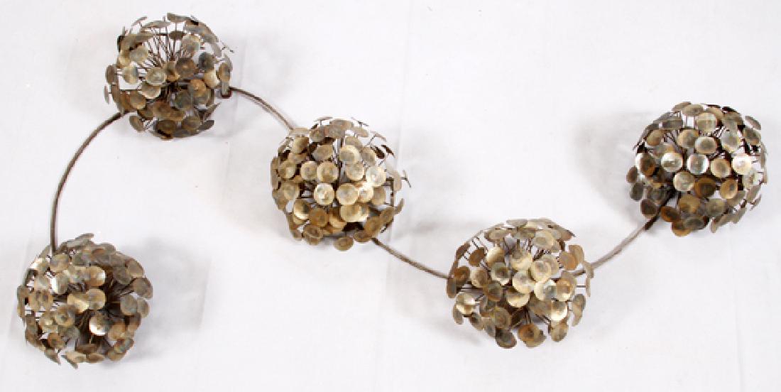 JERE STYLE METAL WALL SCULPTURE 5: JERE STYLE, METAL WALL SCULPTURE, 5, H 27", L 56", FLORAL BOUQUETS:Jere style metal wall sculpture, depicting five bouquets of flowers formed from metal discs and attached to a serpentine wire frame.