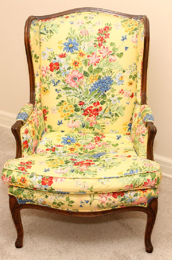 LOUIS XVI STYLE CARVED WALNUT WINGBACK CHAIR: LOUIS XVI STYLE CARVED WALNUT WINGBACK CHAIR, H 42", W 27":20th century. Having yellow floral upholstery.