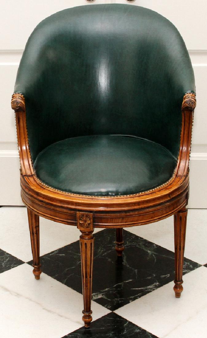 MODERN LOUIS XVI STYLE WALNUT LEATHER SWIVEL CHAIR: MODERN LOUIS XVI STYLE CARVED WALNUT GREEN LEATHER SWIVEL CHAIR:Having green leather upholstery with brass nailhead trim, and stop fluted tapered legs.