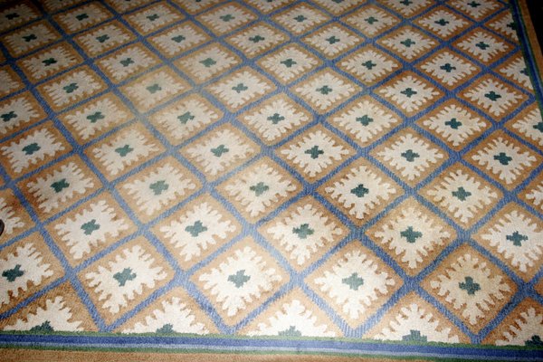 EDWARD FIELDS WOOL RUG, 13' 6"x11' 10": EDWARD FIELDS, VIRGIN WOOL RUG WITH DIAMOND SHAPE DESIGN, 13' 6" X 11' 10":Having a ivory and beige ground with overall green diamond and leaf pattern.