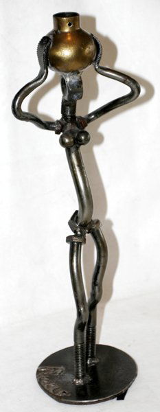RUUX NUT & BOLT SCULPTURE OF FEMALE W/ JUG: RUUX, SCULPTURE OF FEMALE HOLDING JUG, MADE OF NUTS AND BOLTS, H 16":Signed Ruux. From a fine collection,Upper Straits Lake, West Bloomfield.