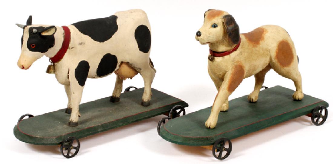 R. SMITH AND R. SHRODE WOODEN COW AND DOG PULL TOYS: R. SMITH AND R. SHRODE, WOODEN COW AND DOG, PULL TOYS, CIRCA 1985, 2 PCS., H 10", L 14 1/2", D 5 1/2":Modern wooden pull toys, one in the form of a dog the other in the form of a cow. Both are mounted