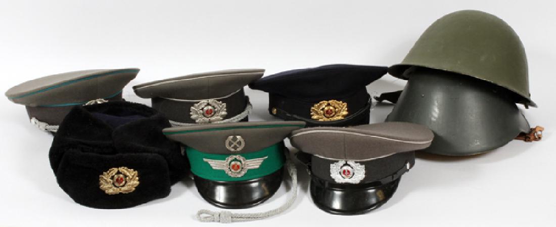 COLLECTION OF EAST-GERMAN OFFICER HATS, ACCESSORIES: COLLECTION OF EAST-GERMAN SOVIET-CONTROL OFFICERS-HATS, MEDALS,ACCESSORIES,BELTS,ET-AL, (1) BOX SIZE;9" H X 17 1/2" L X 12"W.:A.} British Helmet WWII (1)./ B.} E-German Soviet Helmet, (1)./ C.}East-G 