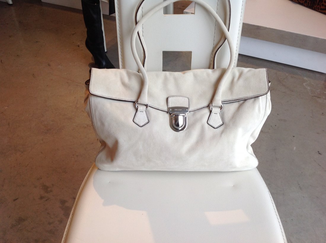 BEAUTIFUL PRADA WHITE SUEDE HANDBAG (NEW): This Handbag is Exquisite. Never Worn, Excellent Condition. The size is 14" x 11". Inside zippered compartment. The pictures do not do this bag justice. Celebrity owned.ORIG. PRICE $1400 BIJOU LUXURY