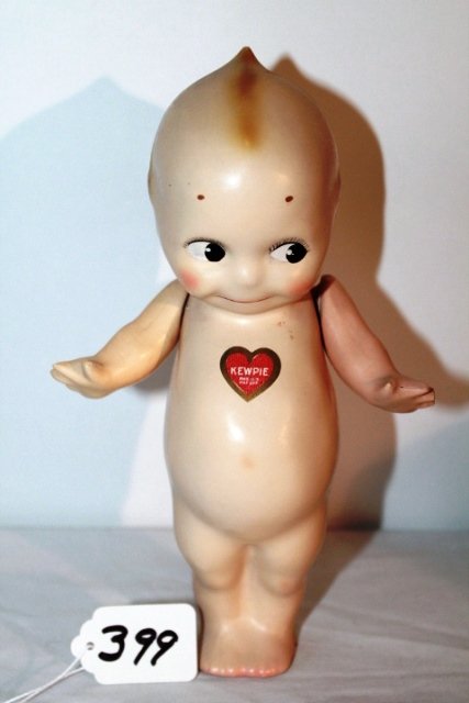 9" - RED HEART STICKER ON CHEST. RECTANGULAR STICKER ON: 9" - RED HEART STICKER ON CHEST. RECTANGULAR STICKER ON BOTTOM OF FEET READS, "KEWPIE/ REGULAR U.S. PAT. OFF./ DES. PAT. JULY 22, 1913" IN ORIGINAL TAN BOX WITH "KEWPIE DOLL" LABEL ON END. VERY GOOD C