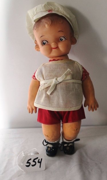 10"; CAMPBELL KID BOY, ALL ORIG. MARKED ON BACK HEAD: 10"; CAMPBELL KID BOY, ALL ORIG. MARKED ON BACK HEAD (CAMPBELL/IDEAL TOY CO.)VINYL HEAD, 1 PIECE BODY, RED AND WHITE ROMPER, APRON 1957 ORIG. CHEF HAT SOME CRACKING ON KNEES. FAIR CONDITION.
