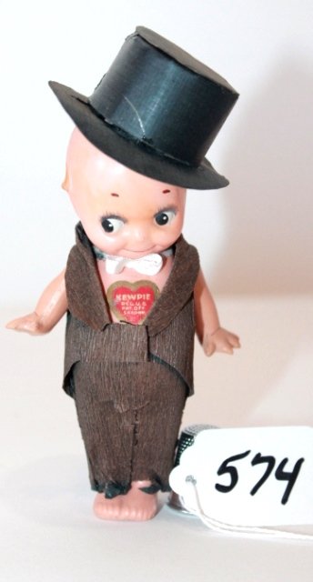 4 3/4" GERMAN CELLULOID KEWPIE STANDING, HEART STICKER: 4 3/4" GERMAN CELLULOID KEWPIE STANDING, HEART STICKER ON CHEST, STICKER READS KEWPIE/REG. US PATENT OFF/SAXONY WEARING BLACK CARDBOARD TOPHAT CREPE LONG TAIL COAT. INCISED 5 3/4/0 GOOD CONDITION.HAT