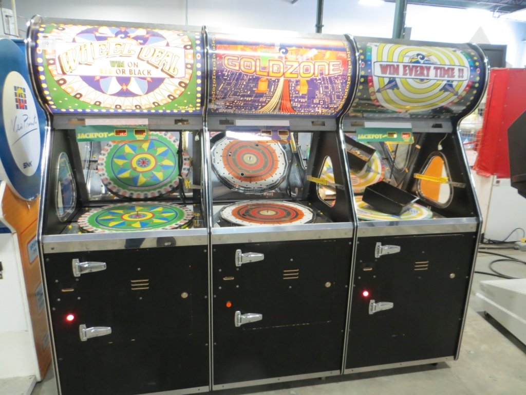 WHEEL DEAL/GOLD ZONE TRIPLE ARCADE: Used item. Powers up unless otherwise noted: Missing front glass, does power up but needs repair.
