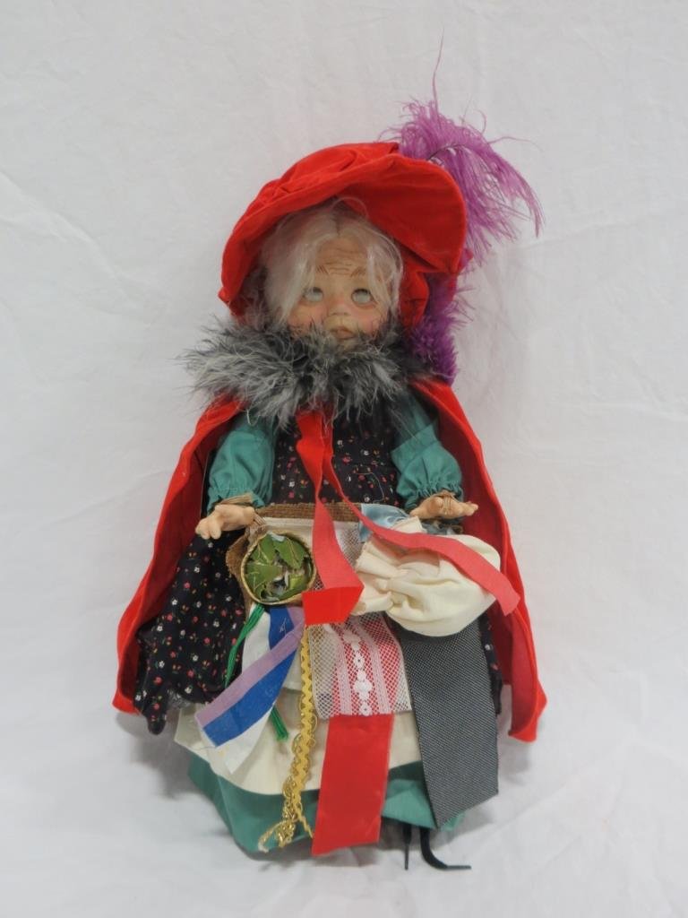 EFFANBEE 1979 PEDDLER DOLL BY FAITH WICK: Condition: Good. Effanbee 1979 Peddler Doll by Faith Wick. Damage to back of cape and eyes are covered with dust.