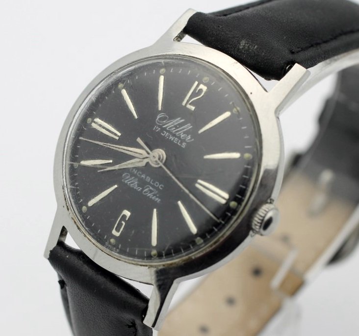 Vintage MILBER UltraThin 17 Jewel Hand Wind All: Men's Stainless Steel 32mm MILBER With Leather Strap. Water Resistant. Incabloc Movement. Watch Is Currently In Working Order. No Buyer's Premium.