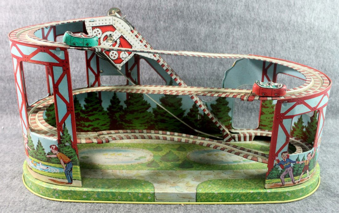 Vintage Mechanical Wind Up Tin Roller Coaster with 2: Vintage Mechanical Wind Up Tin Roller Coaster Chain Playthings measures about 19 in long and 9 in tall Includes 2 cars It is difficult to wind Normal signs of wear colors are nice but a bit faded Ship
