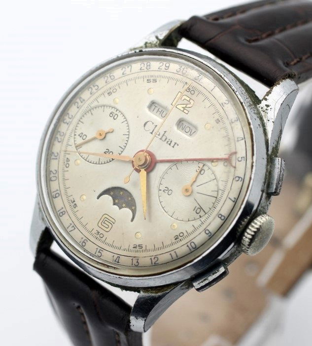 Vintage CLEBAR Triple Date Moonphase Chronograph Watch: Men's Base Metal 35mm CLEBAR. Movement Signed Clebar 17 Jewels. Under Balance Wheel There Is a Star In A Cloud With The #200 Underneath. All Functions Work Properly. Watch Is Currently In Working Orde