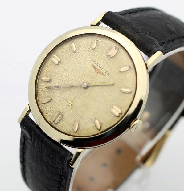 Circa 1958 LONGINES 10 Karat Gold Filled Watch: Men's 10 Karat Gold Filled 32.5mm LONGINES With Ostrich Grain Strap. Calibre 23z. Circa 1958. Stem Has Broken And Needs Replaced. Watch Is Currently In Working Order. No Buyers Premium.
