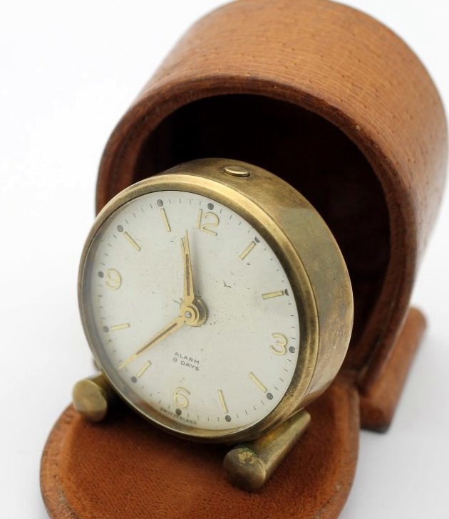 Antique Swiss Made 8 Day Travel Alarm Clock With Case: Brass 2" Swiss Made Alarm Clock. All Functions Work Properly. Includes Case Shown. Clock Is Currently In Working Order. No Buyers Premium.
