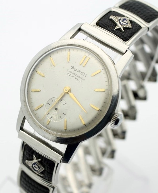 Vintage BUREN Masonic Hand Wind 23 Jewel Stainless: Men's Stainless Steel 34.5mm BUREN With Masonic Stretch Band. Circa 1960's. 23 Jewel Hand Wind Movement. Watch Is Currently In Working Order. No Buyers Premium.