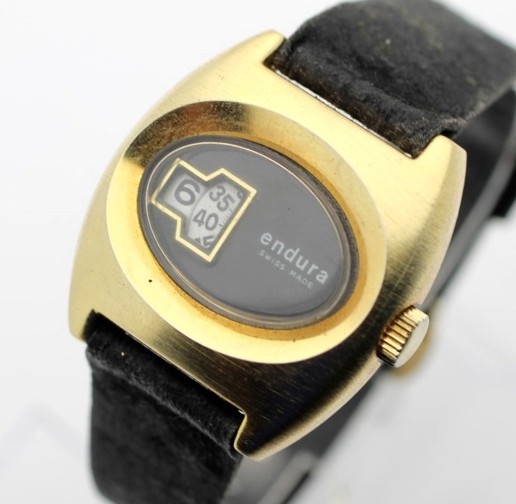 Vintage ENDURA Digital Jump Hour Swiss Made Women's: Women's Base Metal 30.5mm ENDURA. 1 Jewel Hand Wind Movement. Watch Is Currently In Working ORder. No Buyer's Premium