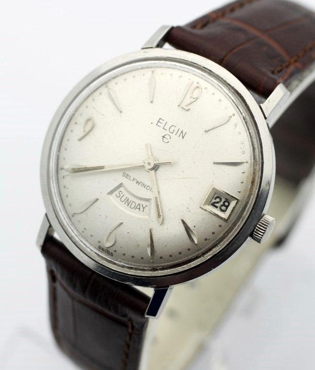 Vintage ELGIN Day Date Automatic Men's Dress Watch: Men's Stainless Steel 34mm ELFIN With Leather Strap. Cailbre 854 17 Jewel Automatic Movement. Watch Is Currently In Working ORder. No Buyer's Premium