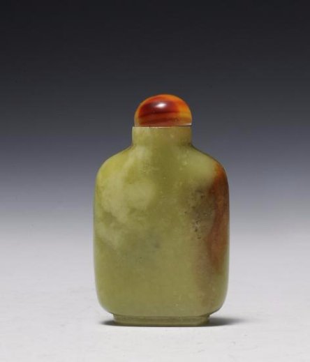 Yellow Jade Snuff Bottle, 18th - 19th Century: Flat, yellow and brown jade snuff bottle from the 18th - 19th century. It is simply carved and has a stopper with a spoon. Dimensions are 1 5/8 inches wide by 2 1/2 inches high. All measurements are a