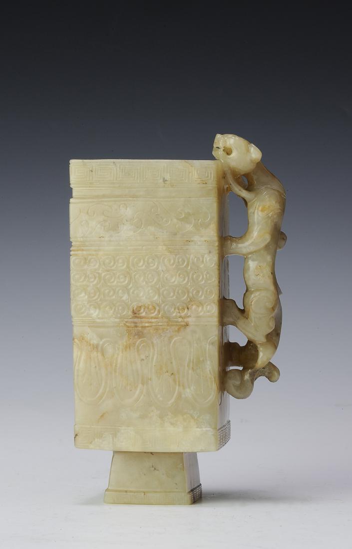 Square Jade Cup w/ Chilong Handle, Ming or Earlier: Square jade cup with a chilong handle from the Ming dynasty or earlier. The cup is tall and rectangular with a square foot. It is carved with geometric designs including Greek Key patterns bordering e