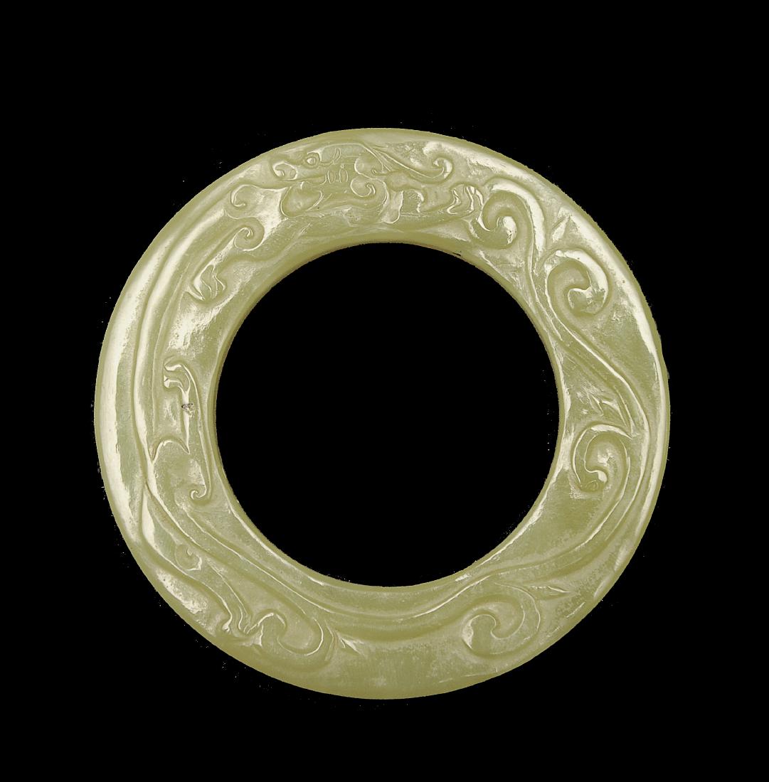 Carved Yellow Jade Ring, Ming Dynasty: Carved yellow jade ring from the Ming dynasty. One side is carved with eight characters while the other side is carved with a sinuous chilong. Dimensions are 2 3/4 inches wide in total diameter and 1/